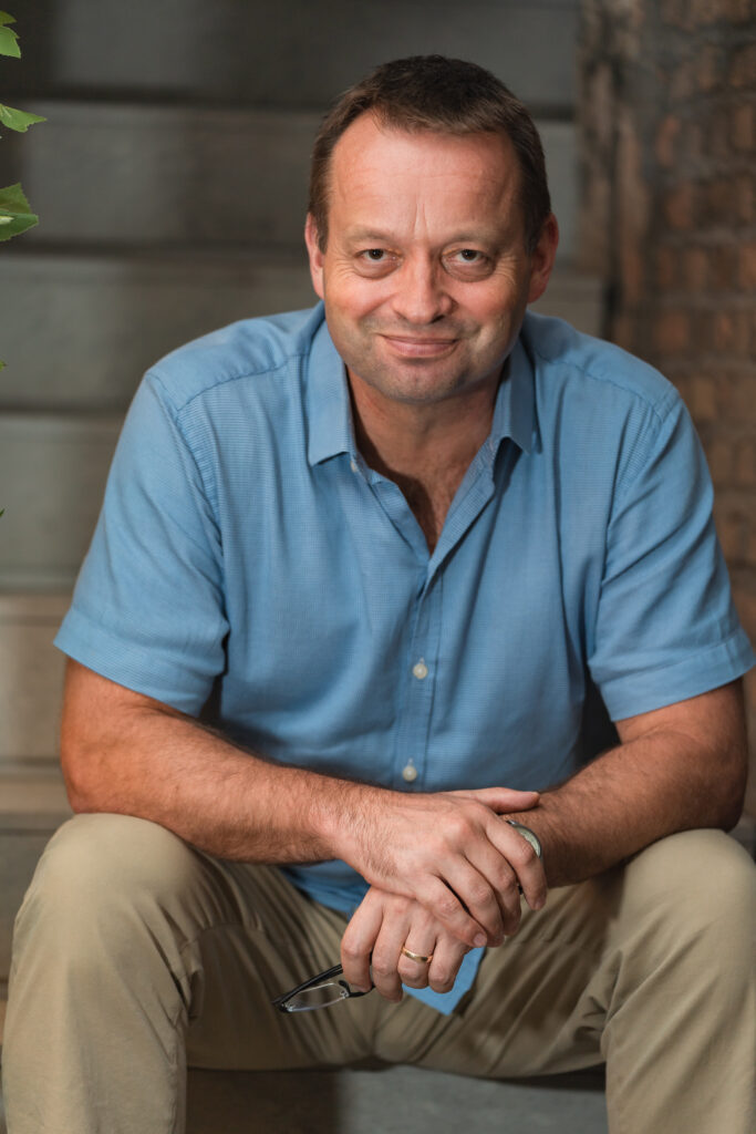 A photo of the author sitting on a staircase